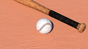 un bate de béisbol y una pelota de béisbol sobre una superficie rosada