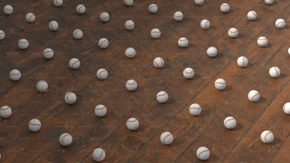 un groupe de boules blanches assises sur un plancher en bois