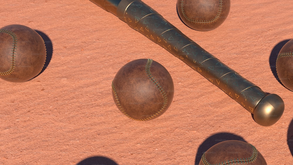 a group of baseballs and a bat laying on the ground