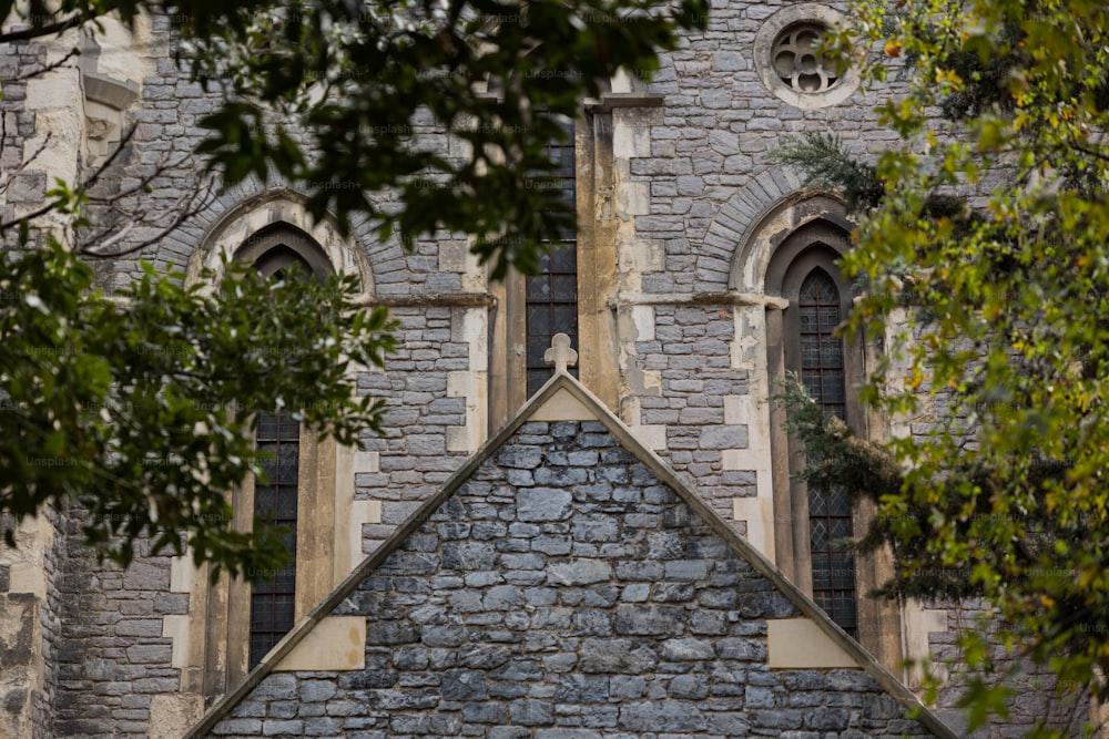 a stone building with two windows and a clock