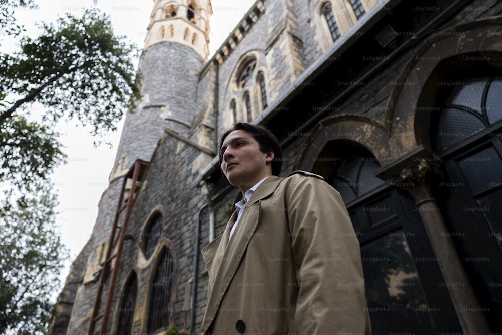 a man standing in front of a tall building