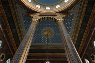 the ceiling of a building with a clock on it