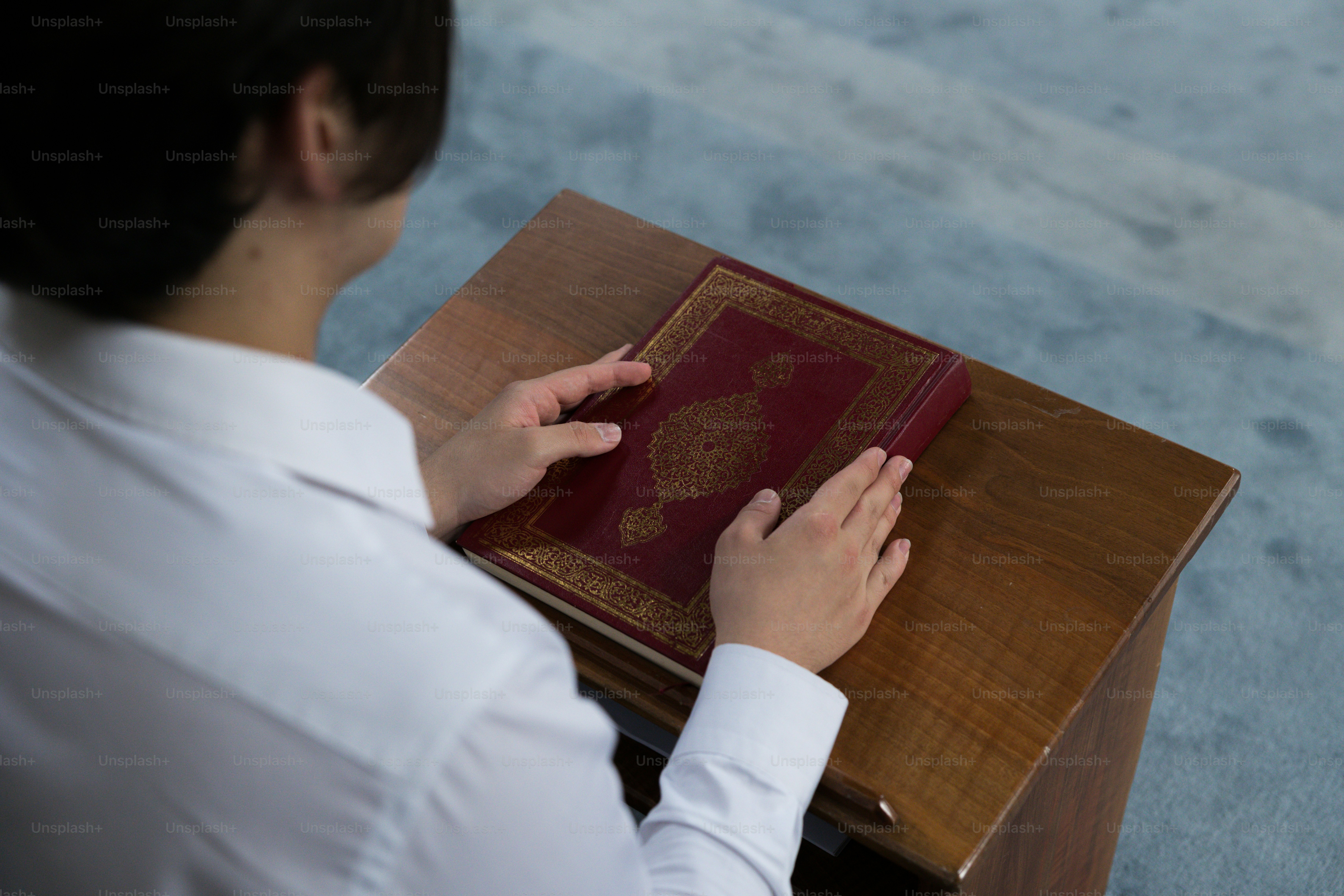a woman is reading a book on a table
