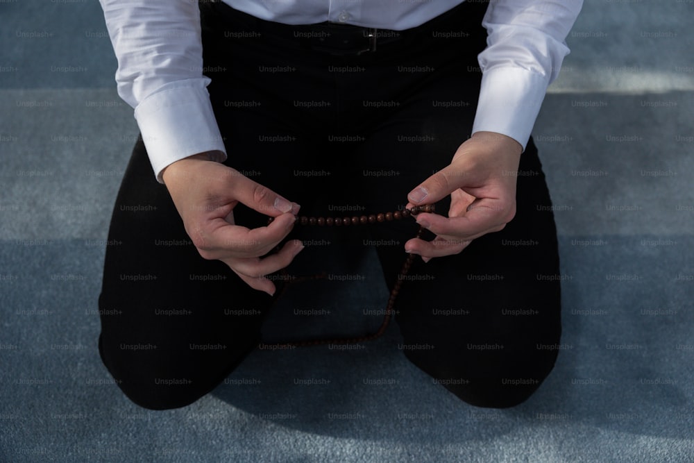 a person sitting on the ground holding a string