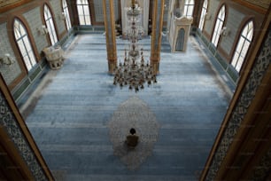 a room with a chandelier and a chandelier hanging from the ceiling