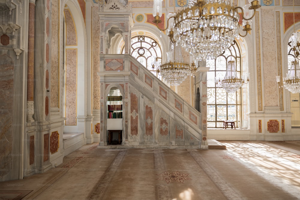 a large room with a staircase and chandelier