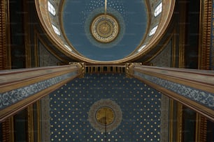 the ceiling of a building with a clock on it