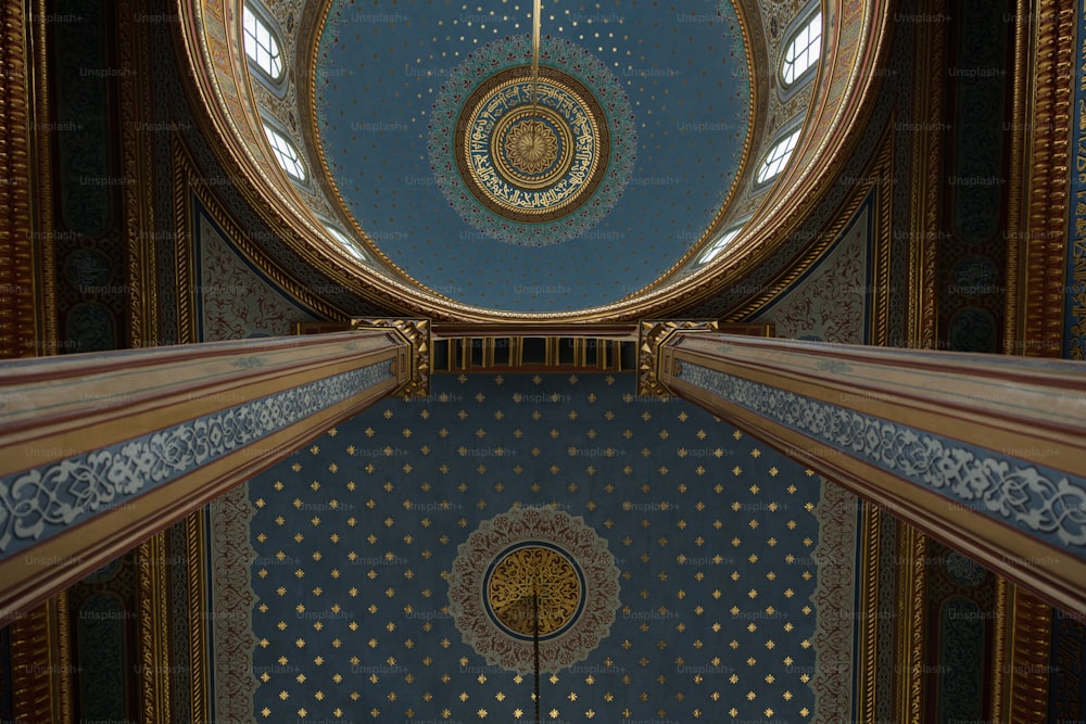 the ceiling of a building with a clock on it