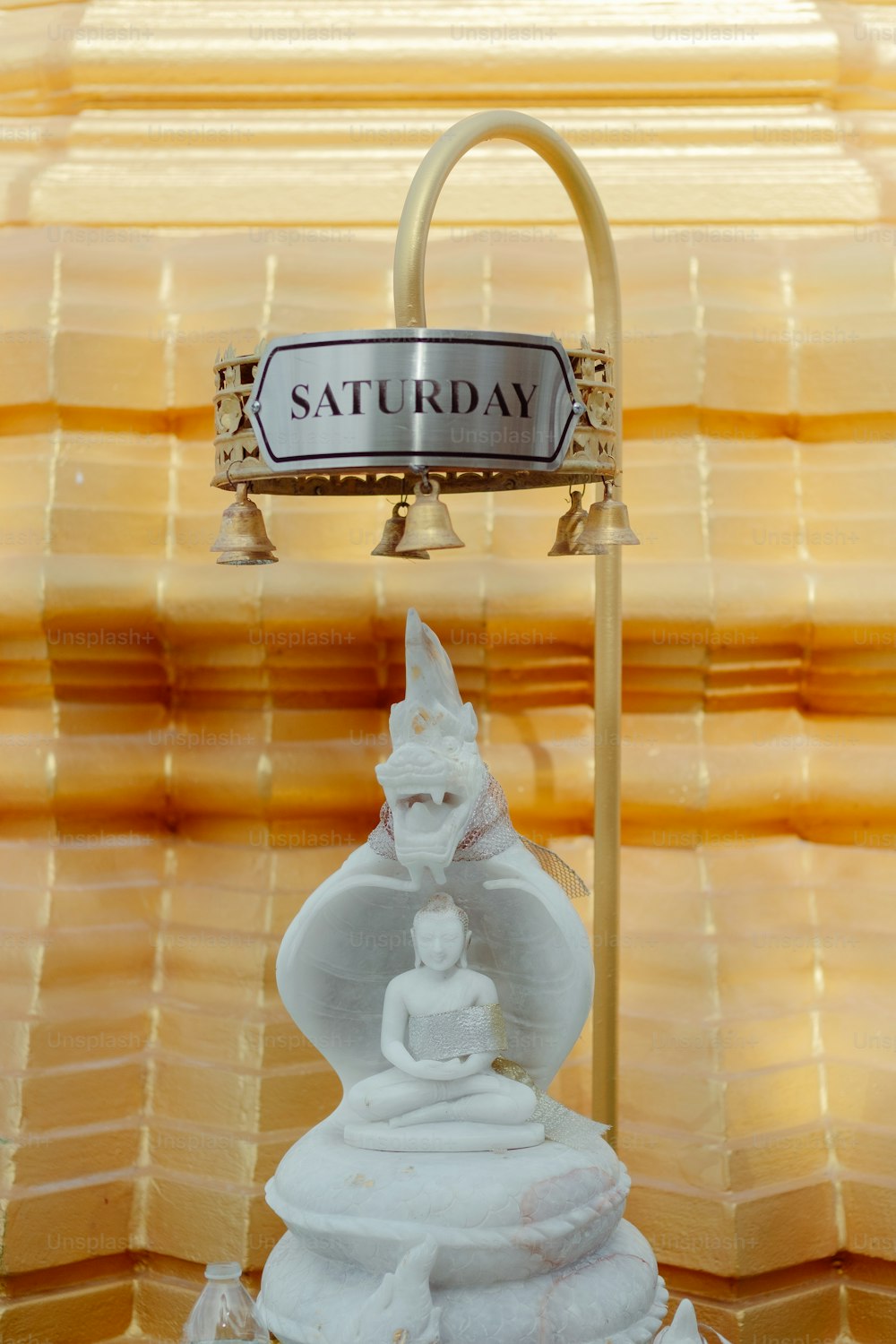 a statue of a buddha in front of a sign