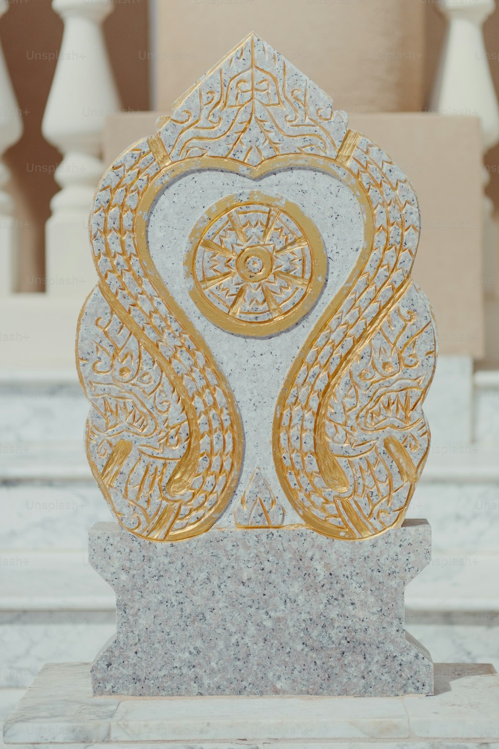 a marble statue with a gold design on it