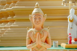 a statue of a buddha sitting on a table