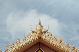 a golden statue on top of a building