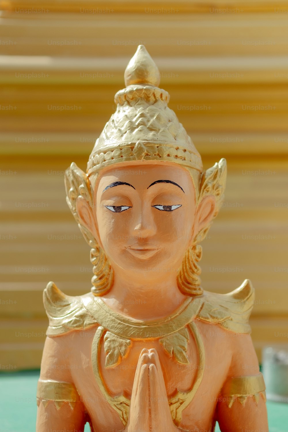 a statue of a buddha sitting on top of a table