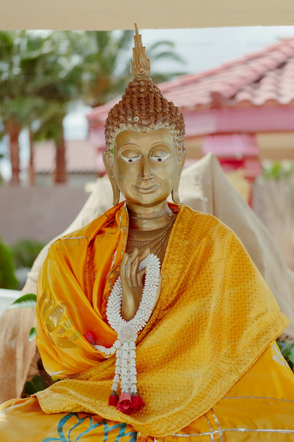 a statue of a person wearing a yellow outfit