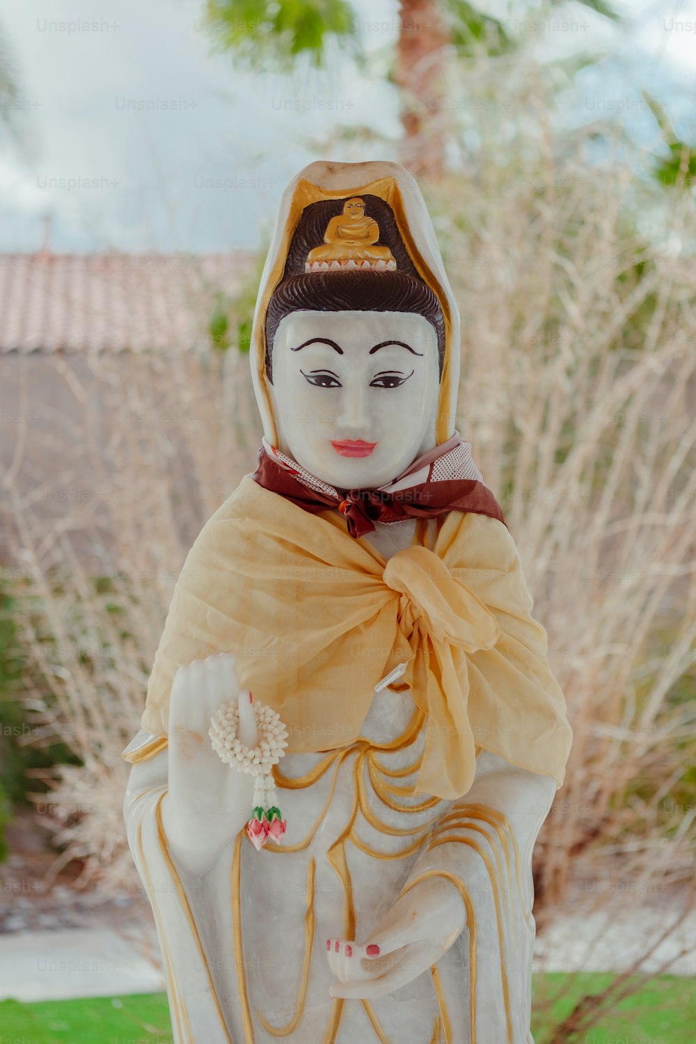 a statue of a person wearing a hat and a scarf