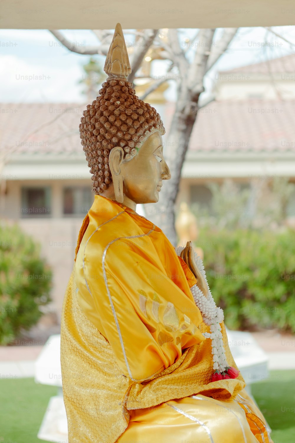 a statue of a person sitting on a bench