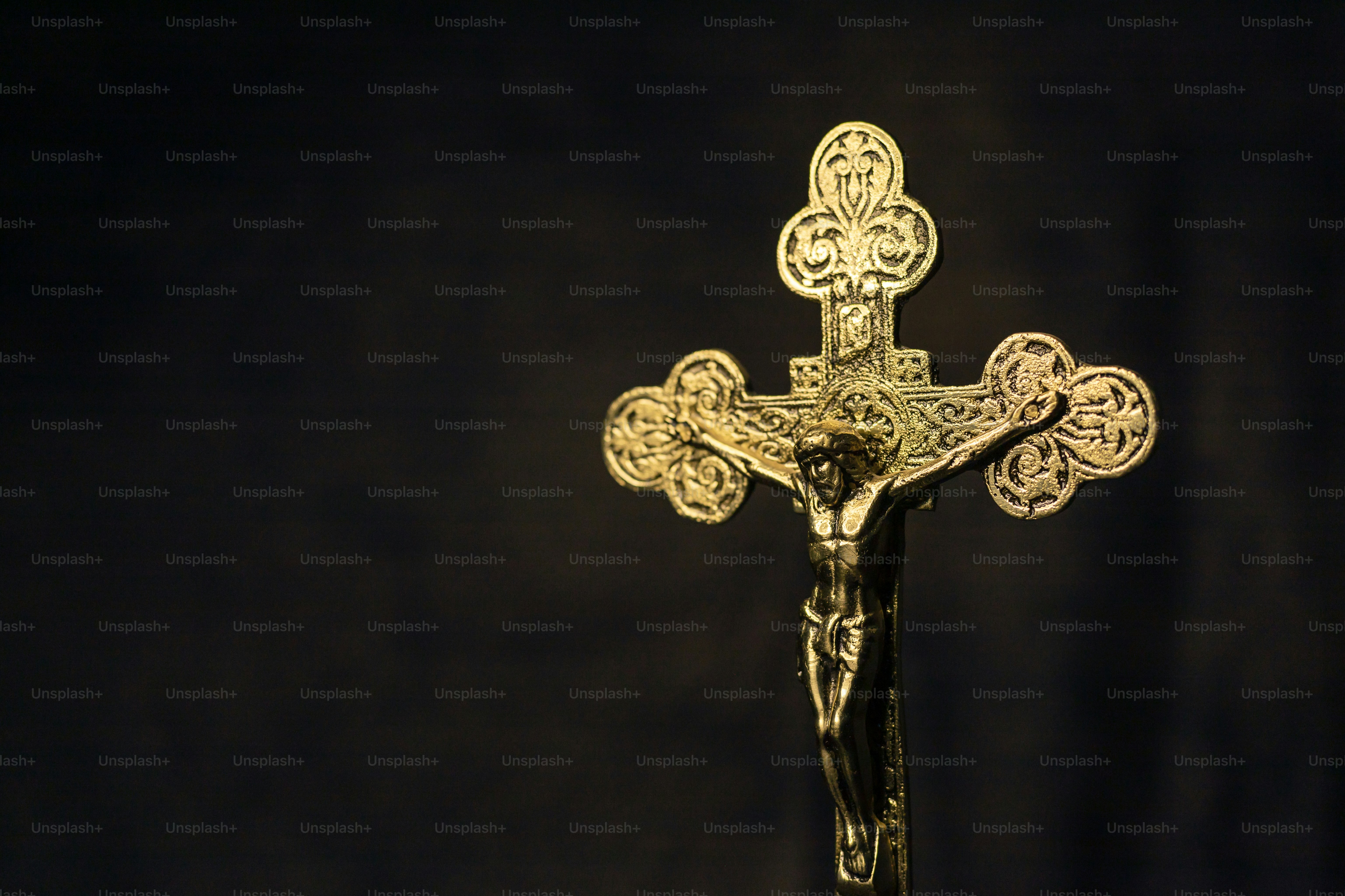 a crucifix is shown against a black background