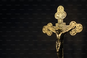 a golden crucifix on a black background
