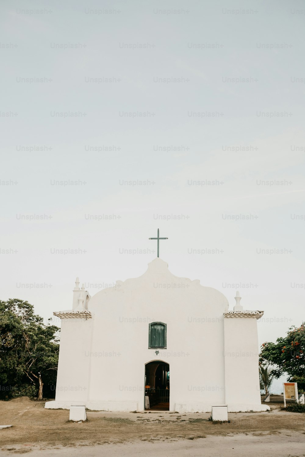 a white church with a cross on top of it