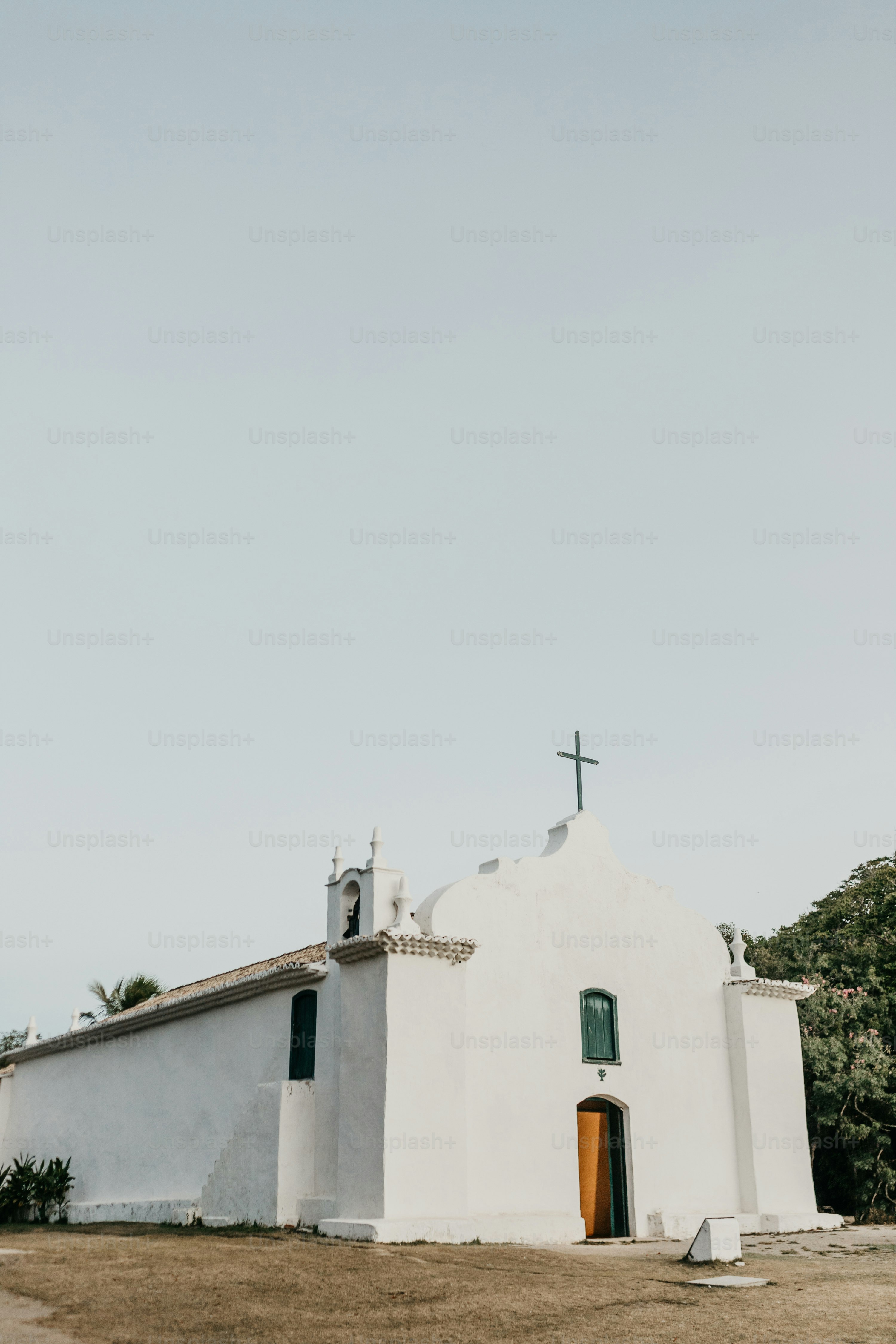 a white church with a cross on top of it