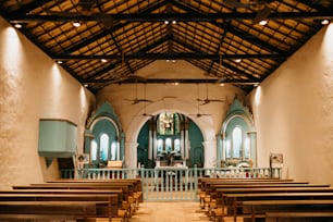 the inside of a church with wooden pews