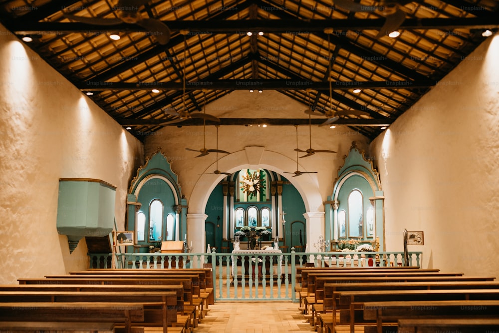 the inside of a church with wooden pews