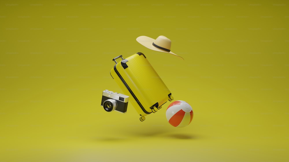 a yellow suitcase with a hat and a beach ball
