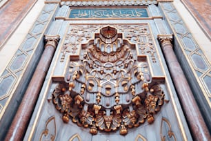 Un primo piano di una porta decorativa con scritte arabe