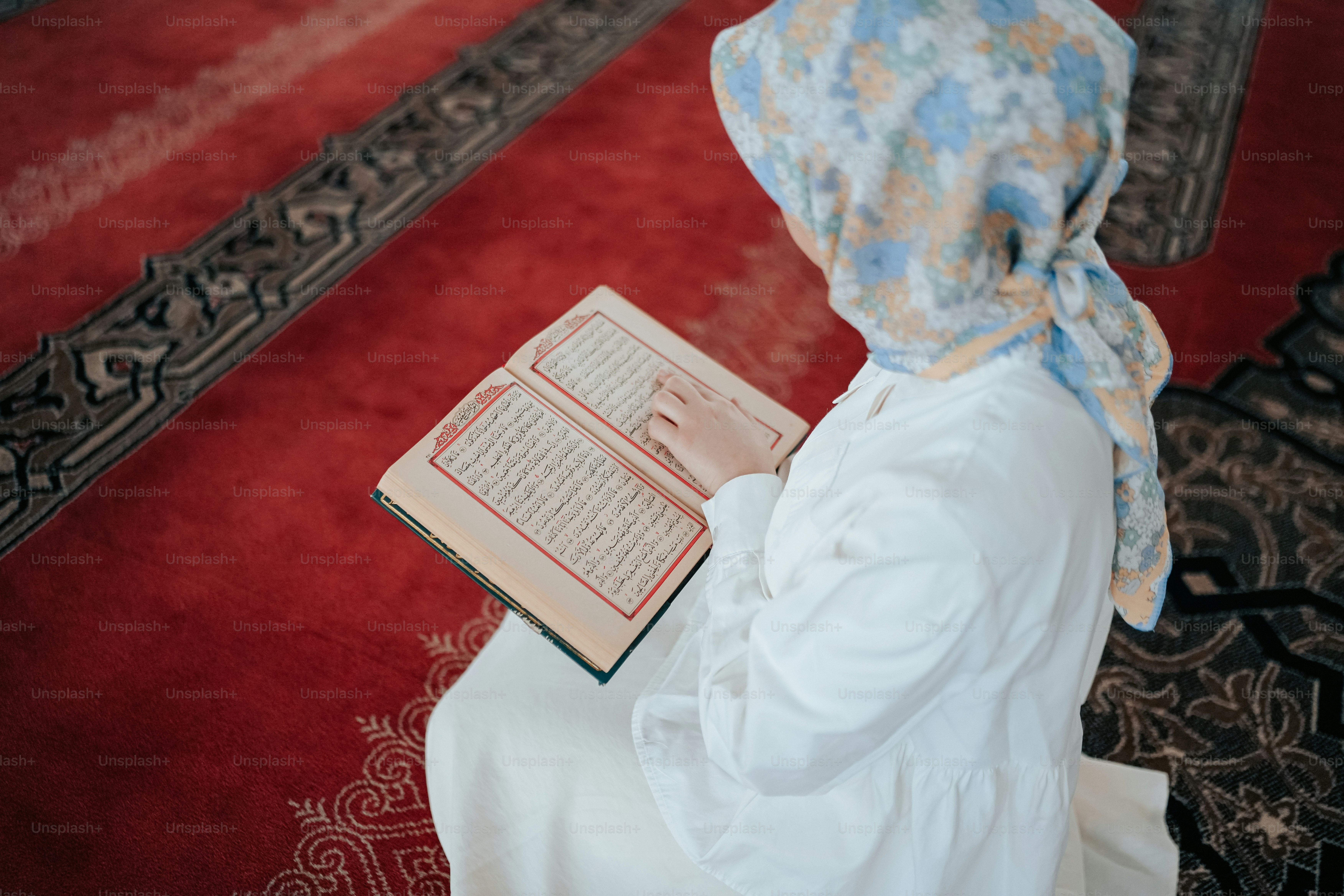 a woman in a headscarf reading a book