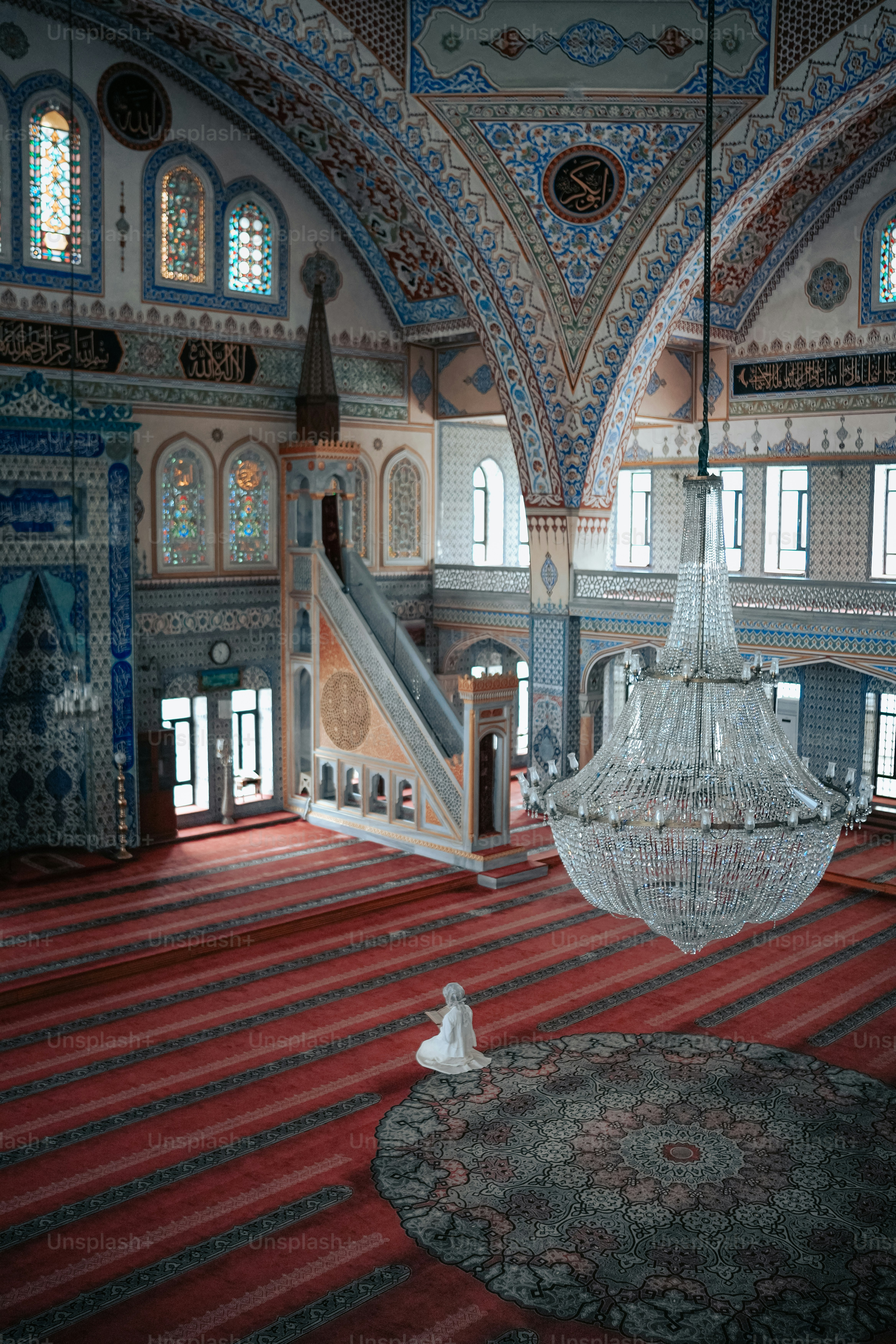 a chandelier hanging from the ceiling of a large room