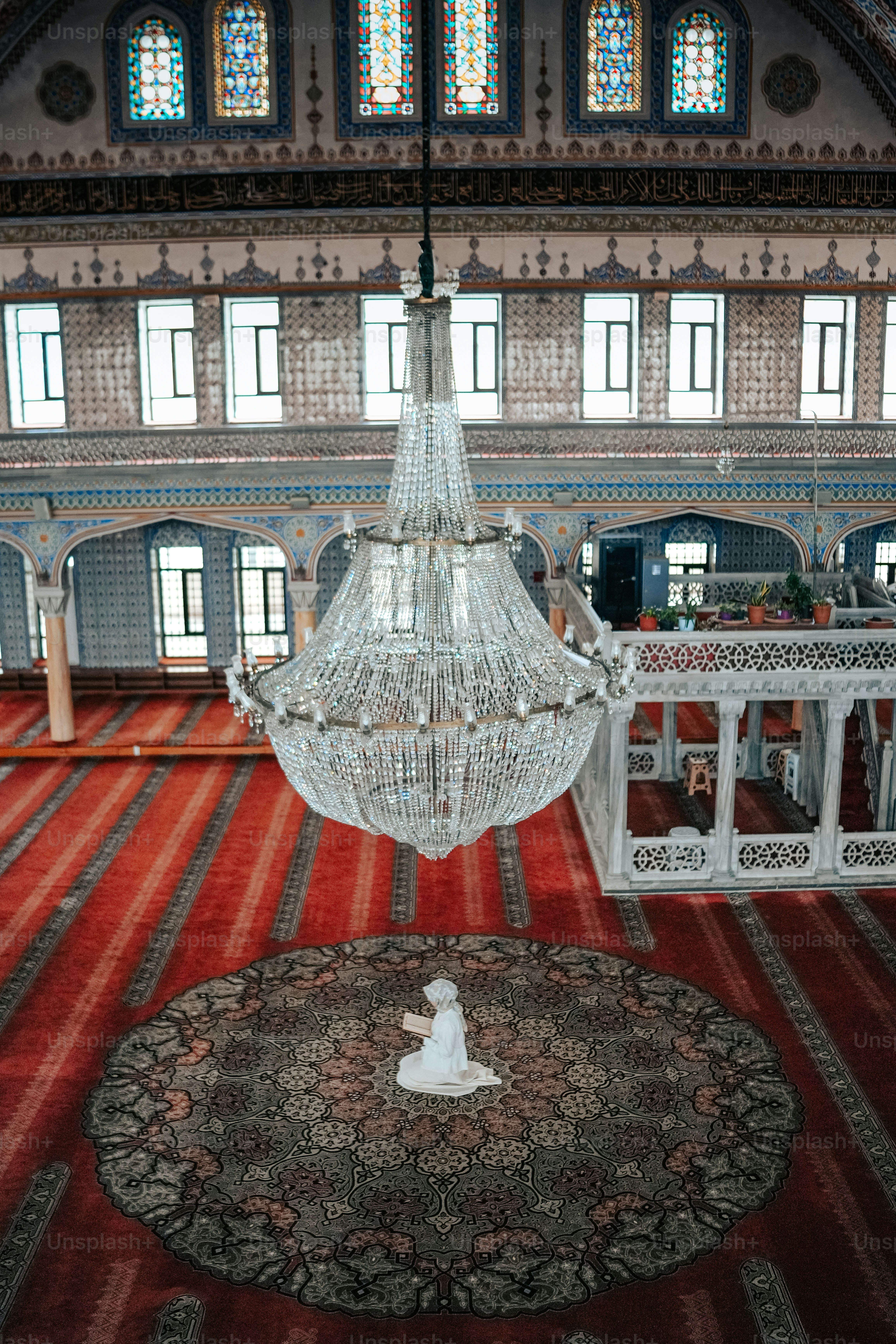 a chandelier hanging from the ceiling of a large room