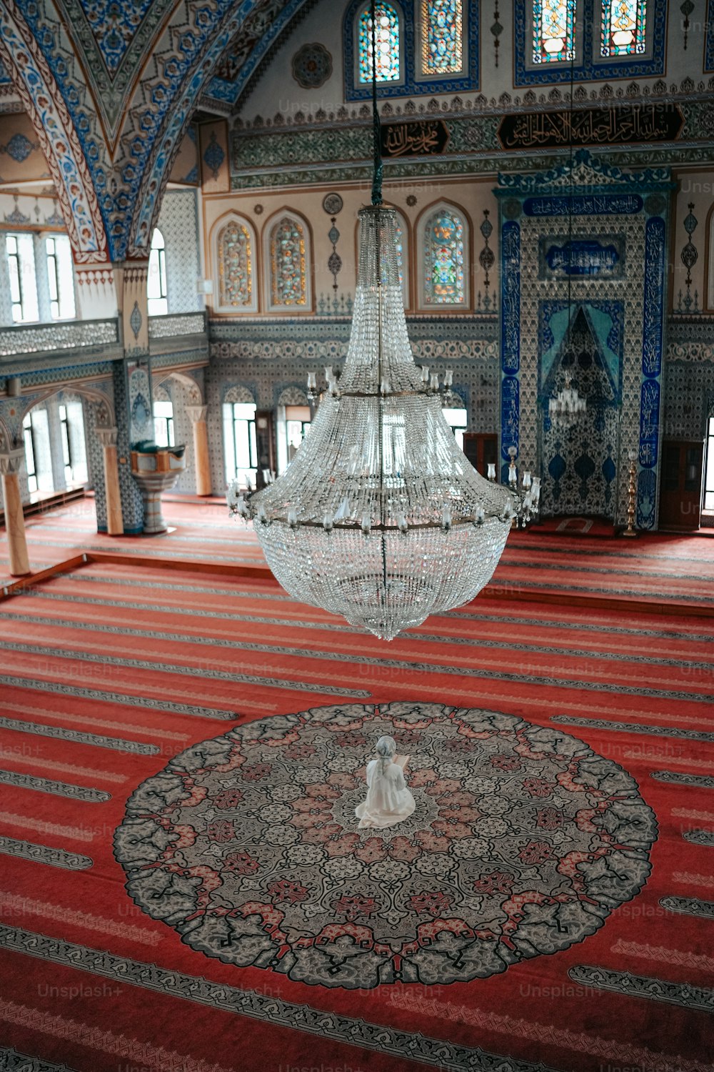a chandelier hanging from the ceiling of a large room