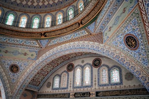 the ceiling of a large building with many windows