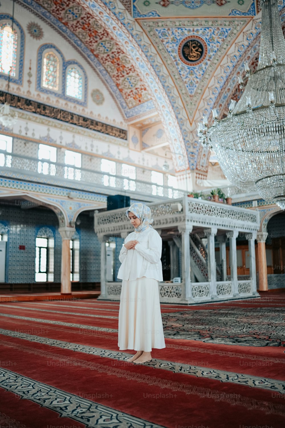 a woman in a white outfit standing in a room