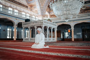 a man sitting on a rug in a large room