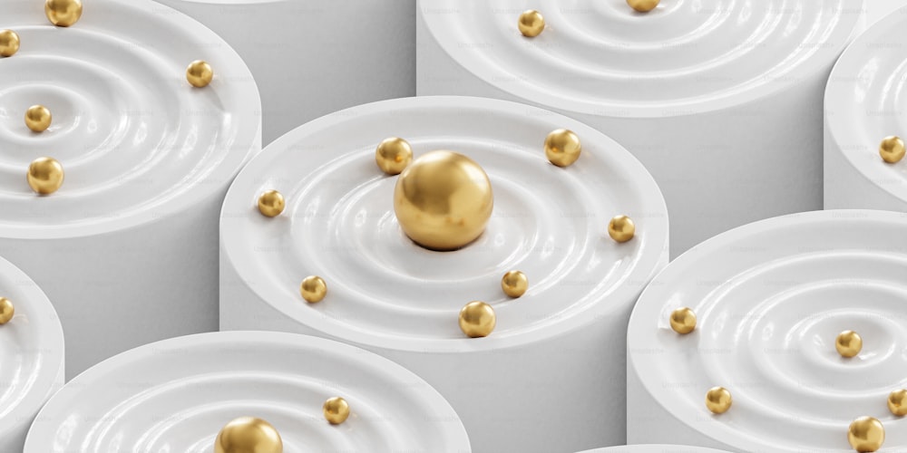 a group of white plates with gold balls on them