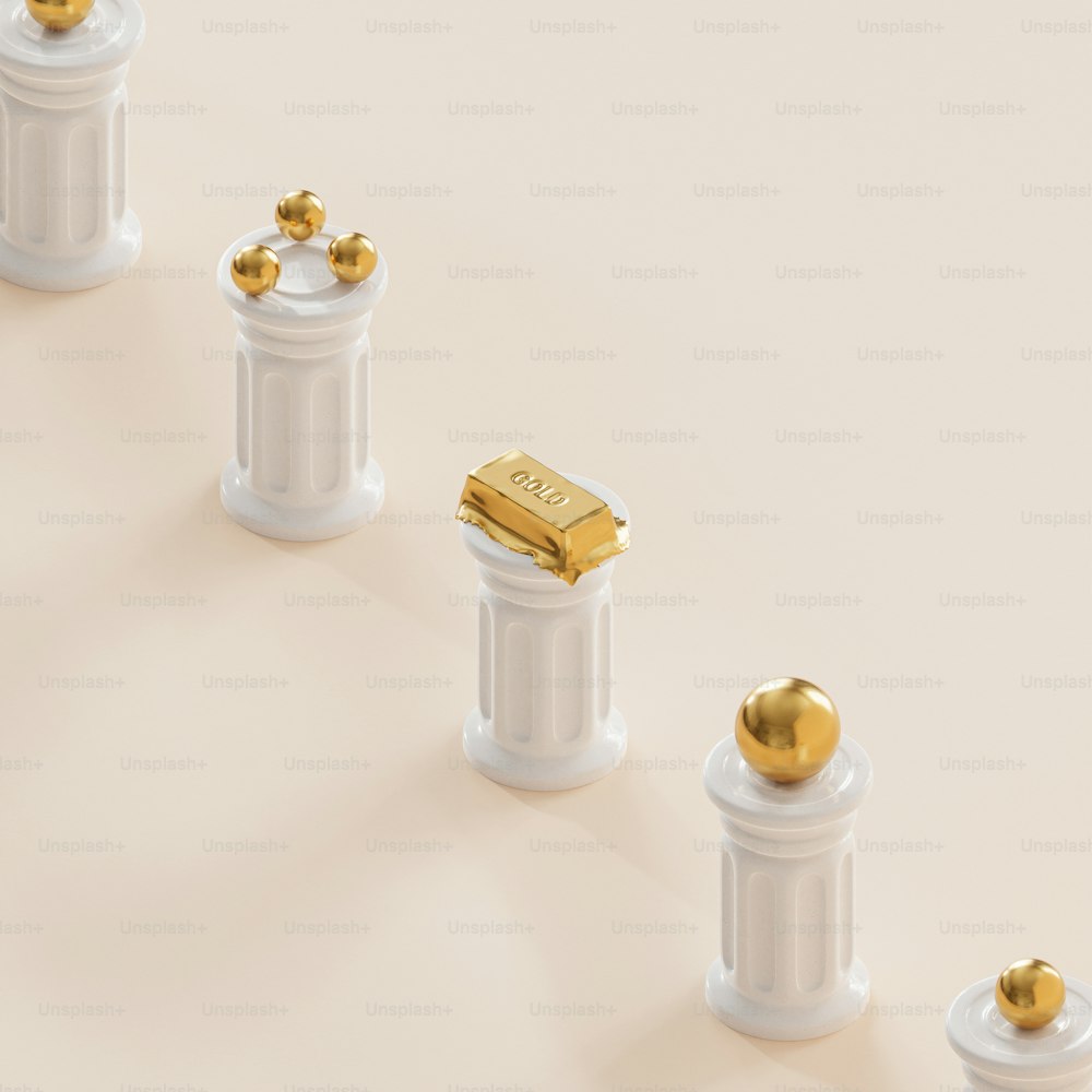 a row of white pillars with gold balls on them