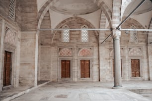 a large room with two doors and a ceiling fan