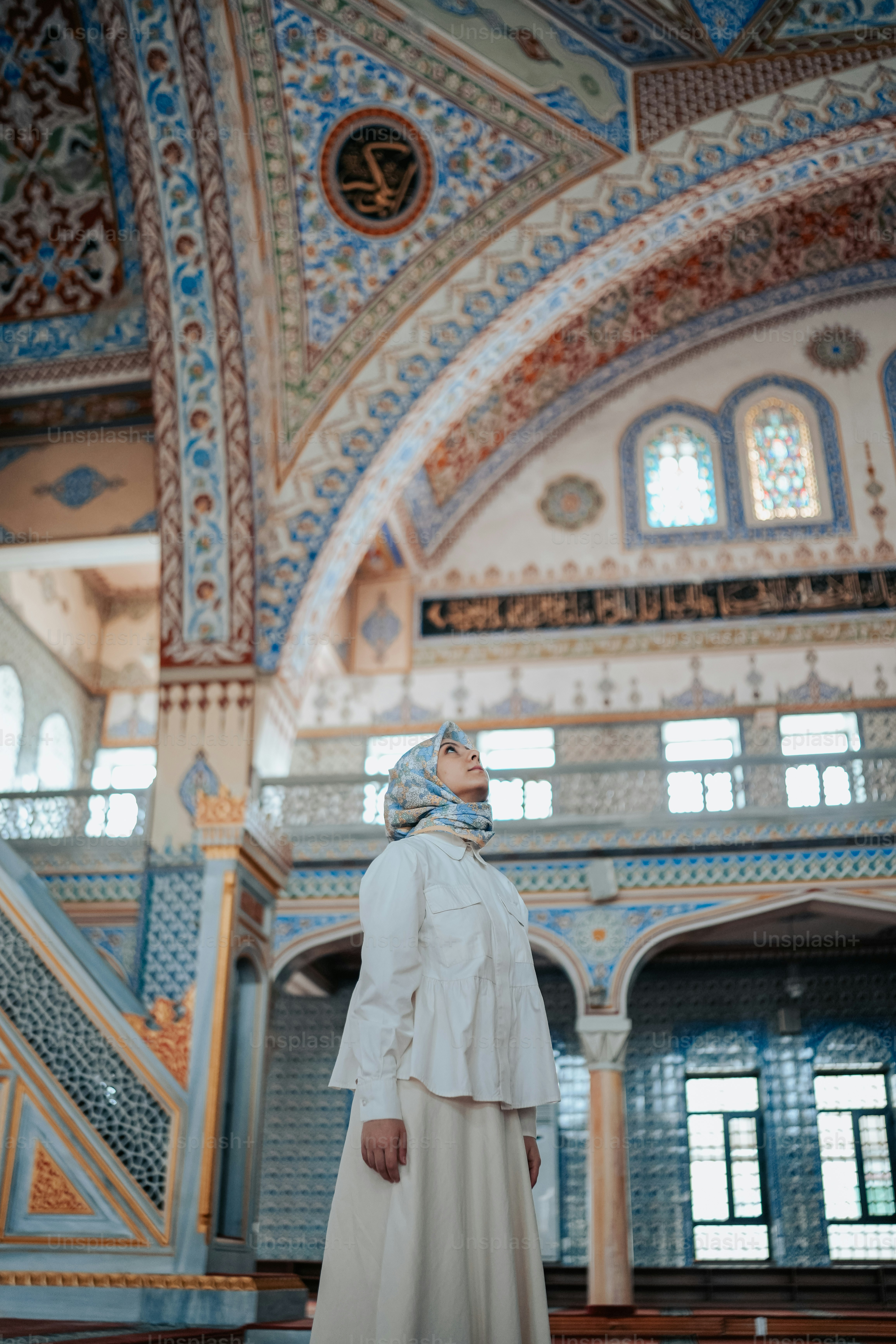 a woman in a white dress standing in a building