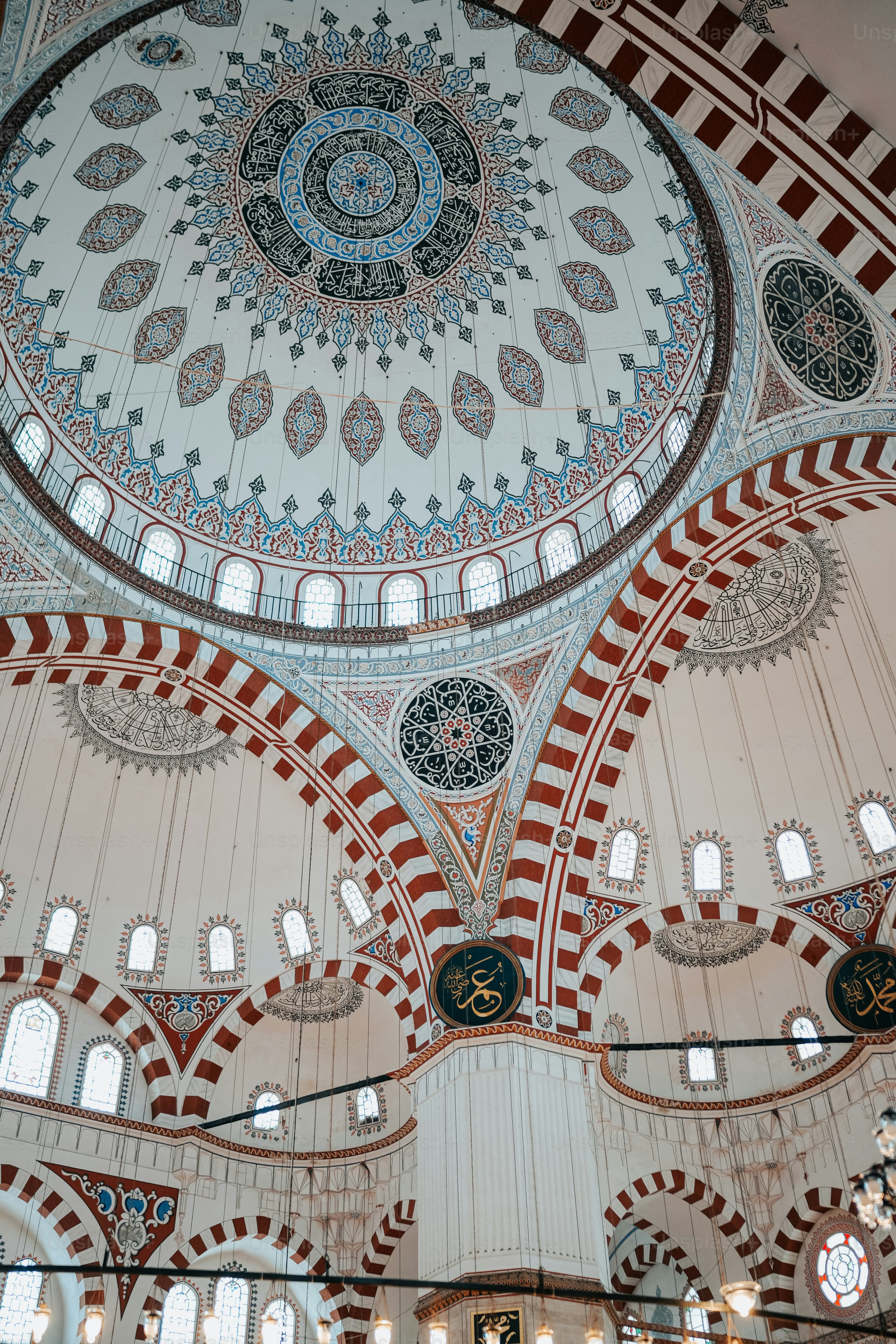 the ceiling of a large building with many windows