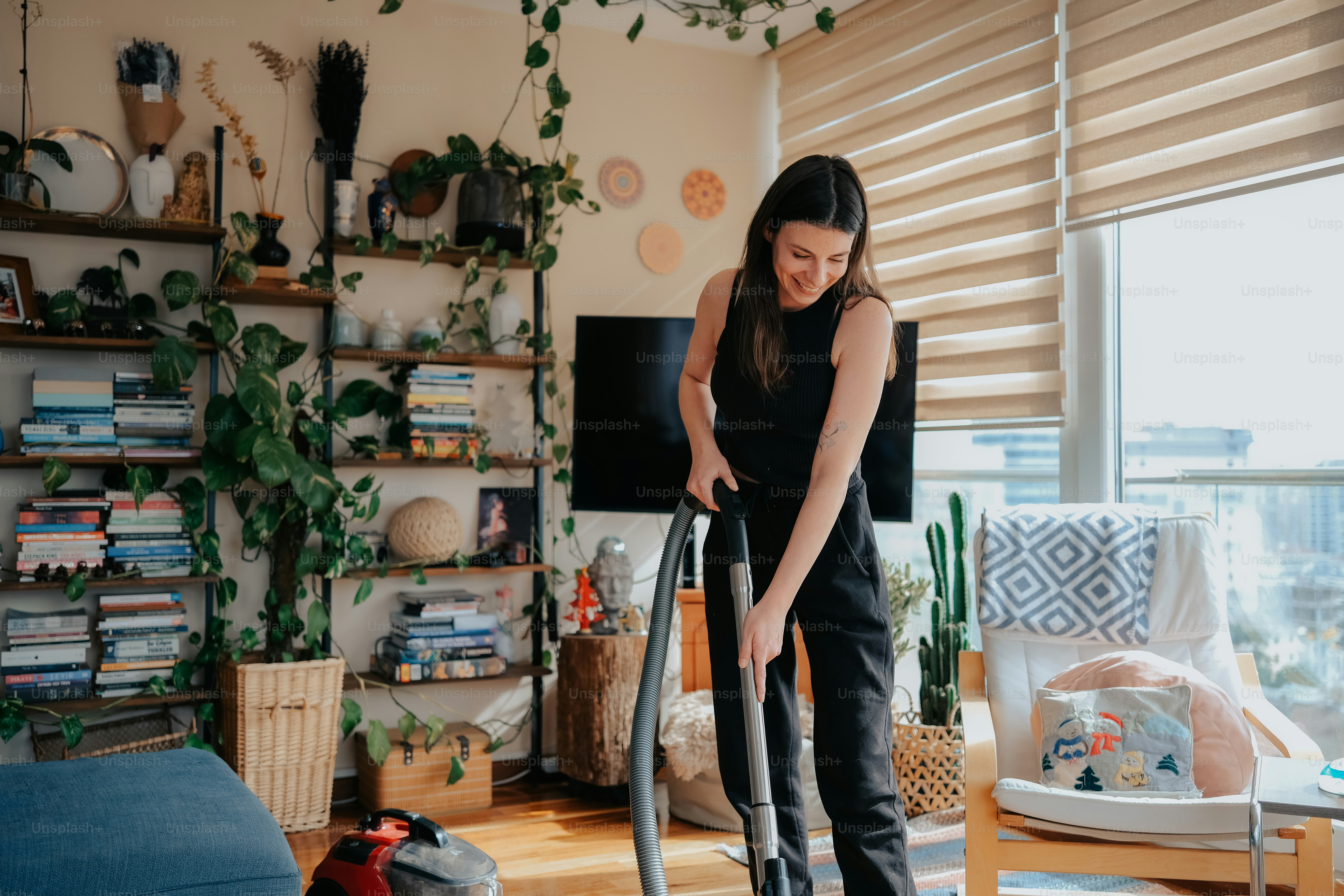 a woman using a vacuum in a living room