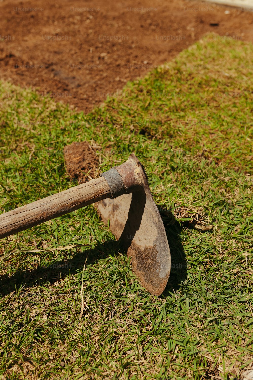 an old axe is laying on the ground