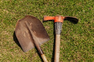 a shovel and a shovel laying on the grass