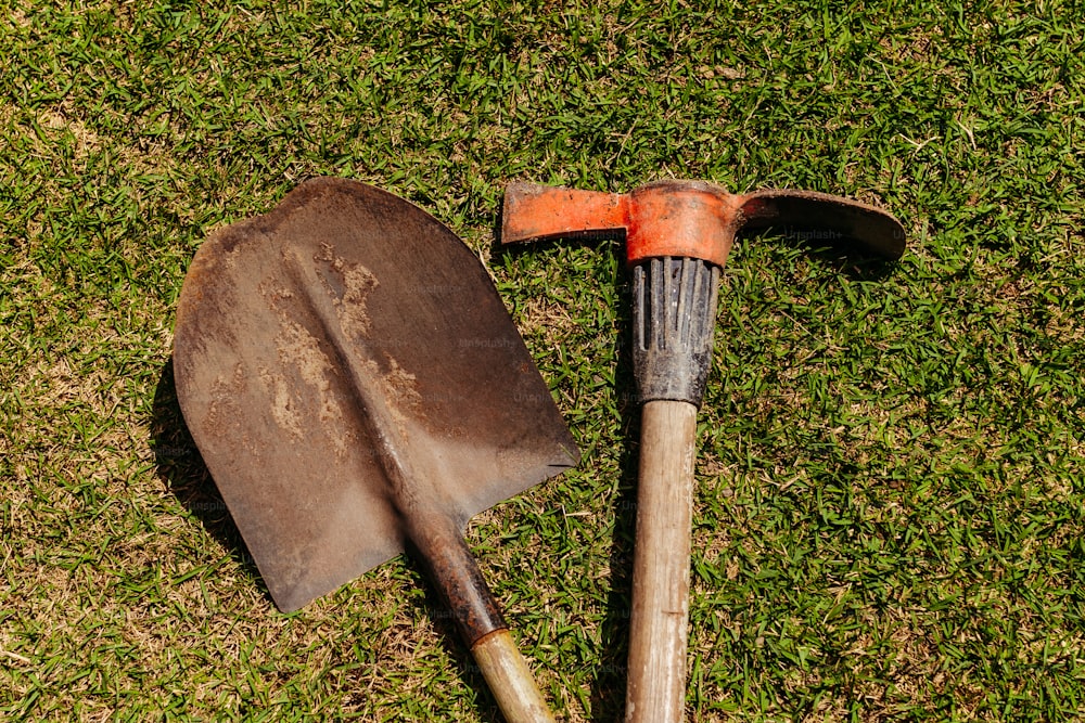 a shovel and a shovel laying on the grass