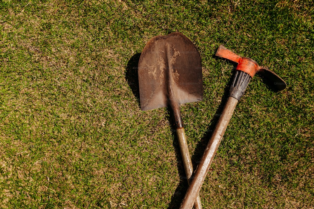 a shovel and a shovel laying on the grass