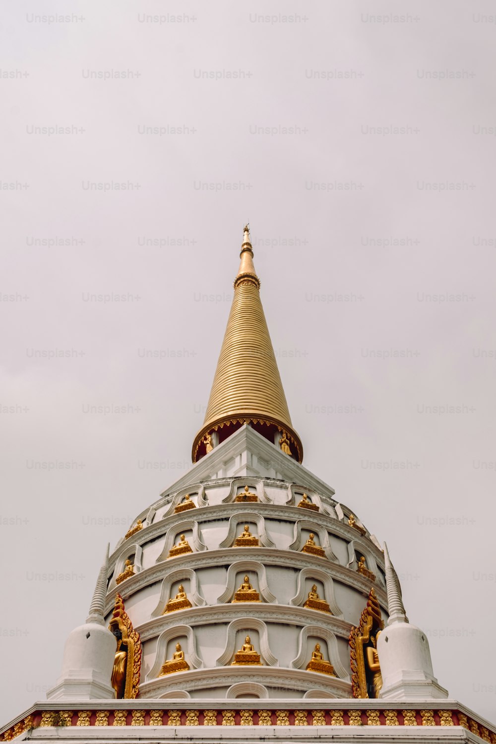 a large white and gold building with a clock on it's side