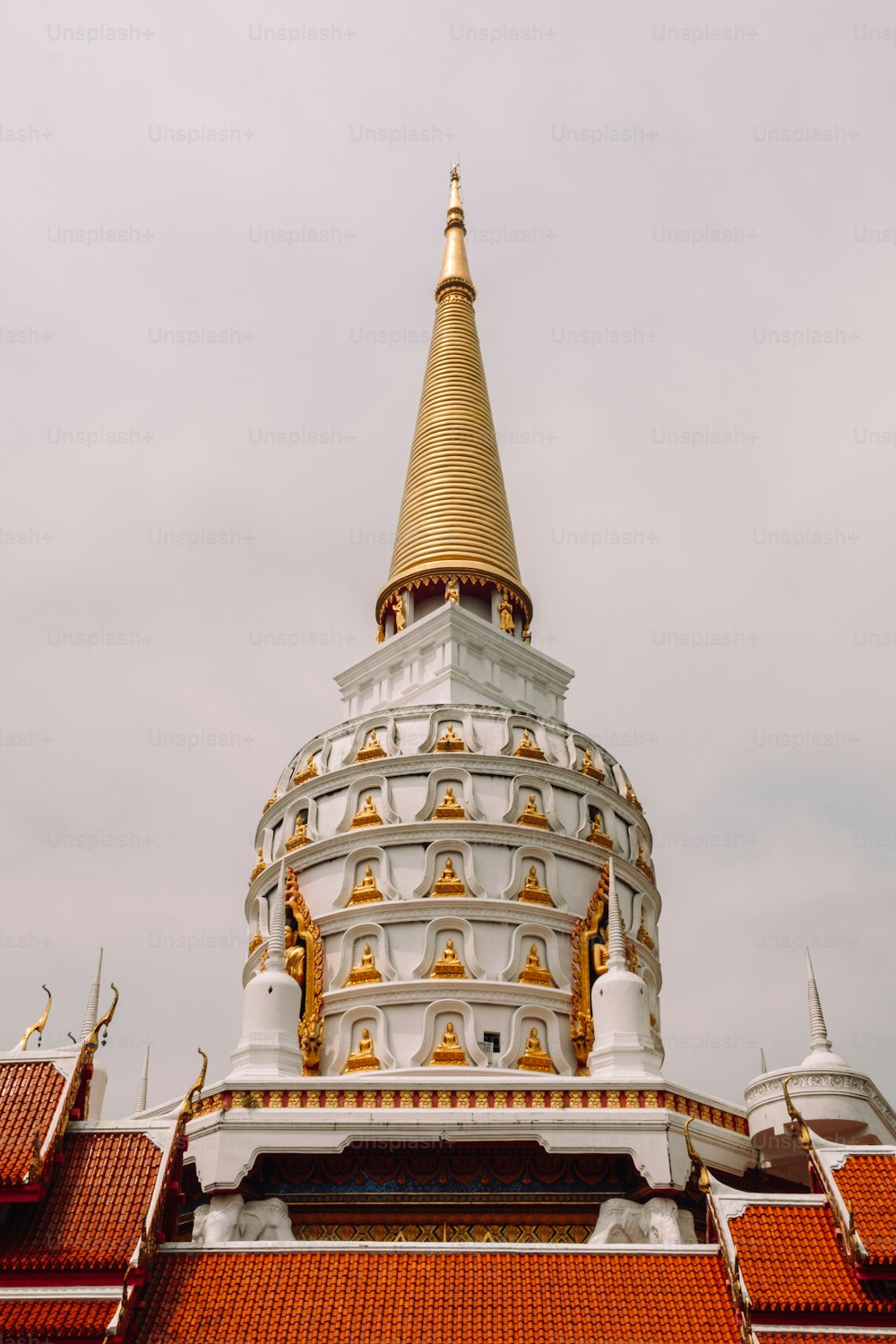 a large white and gold building with a sky background