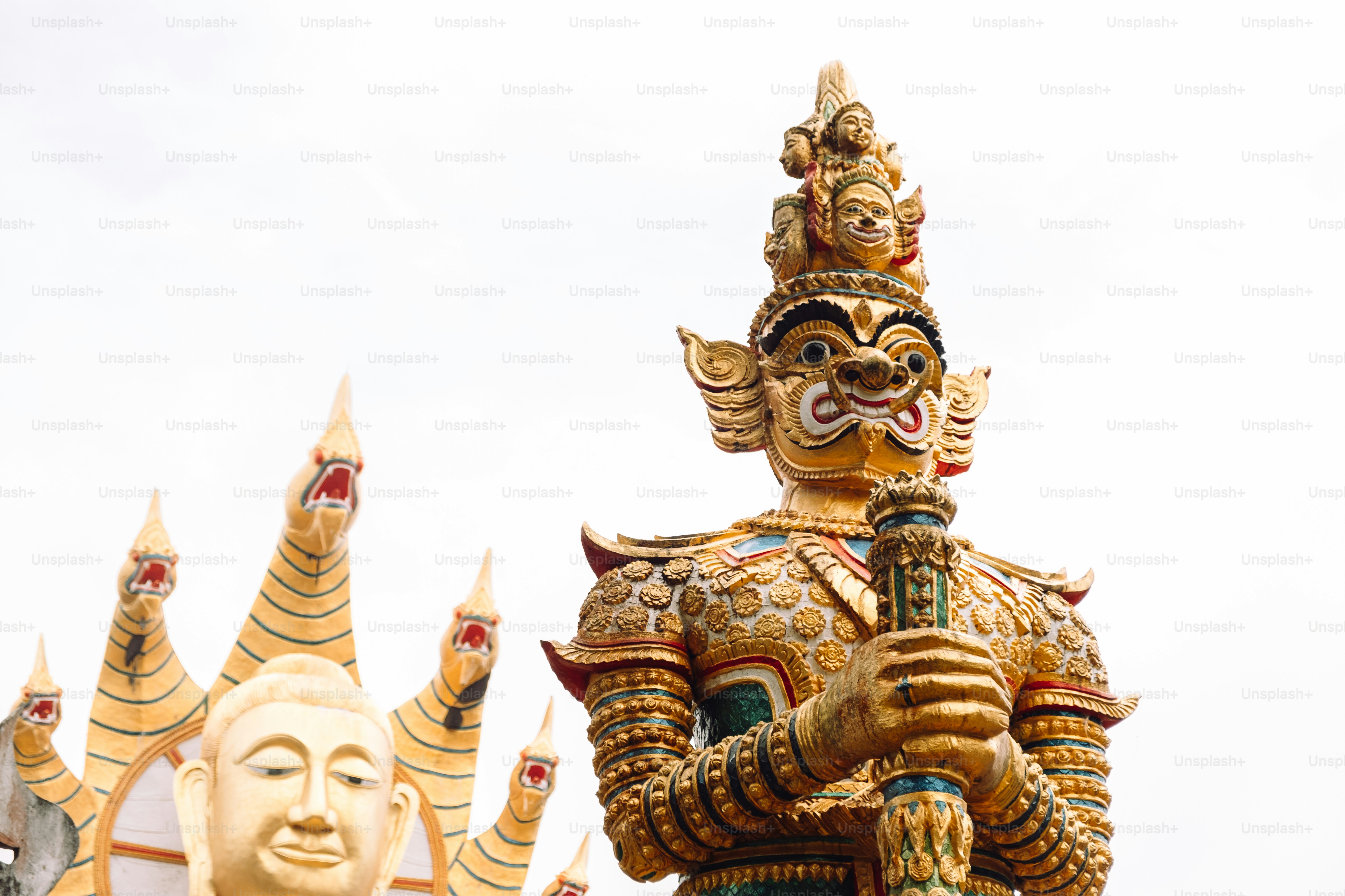 a statue of a man holding a sword in front of a building