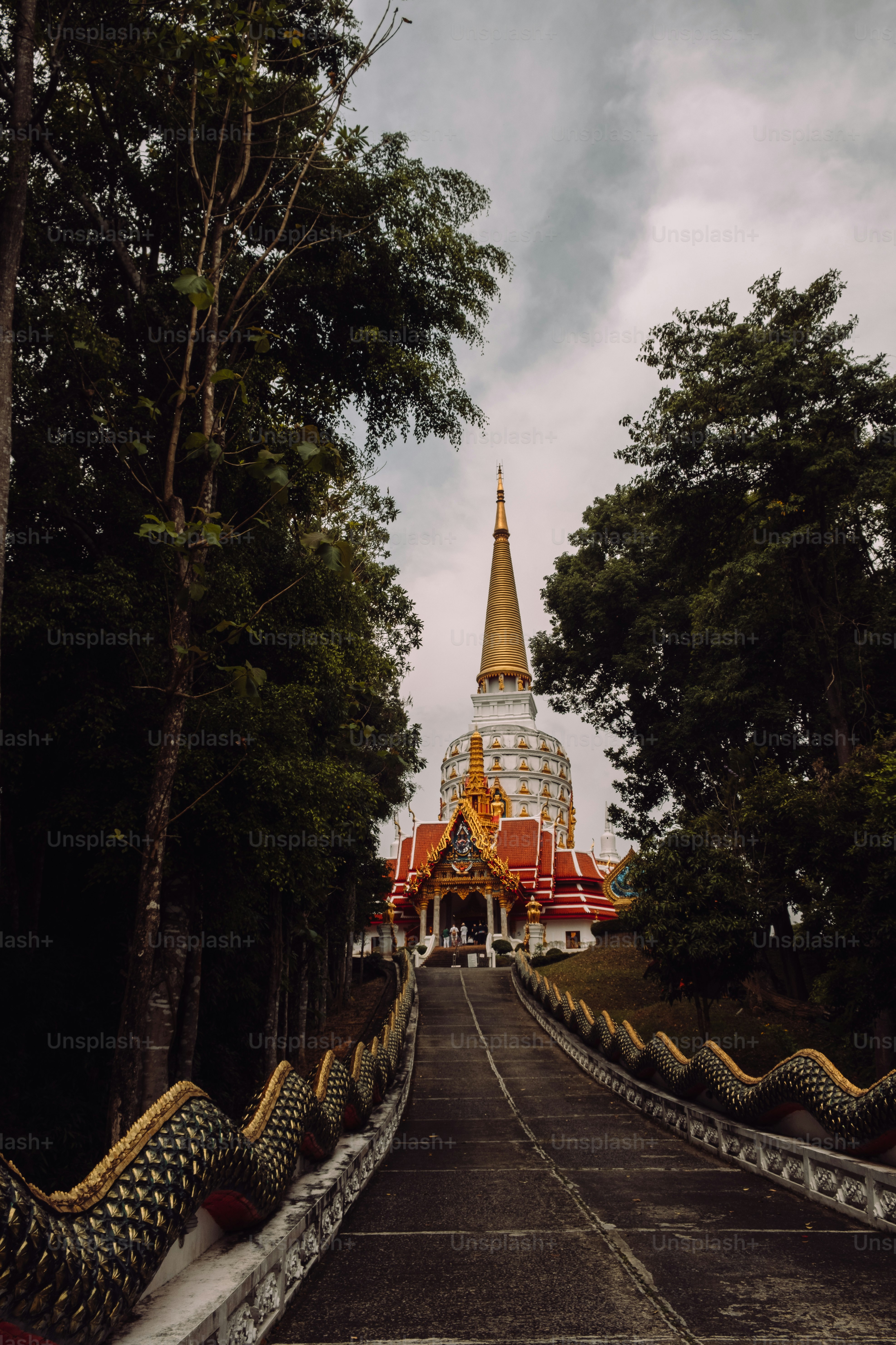 a large white and gold building surrounded by trees