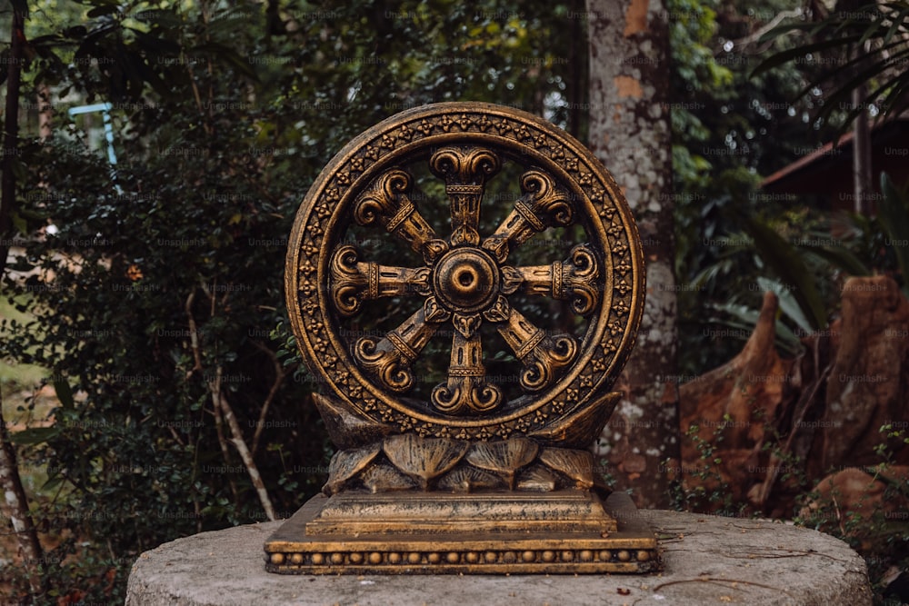 a statue of a wheel of time on a rock